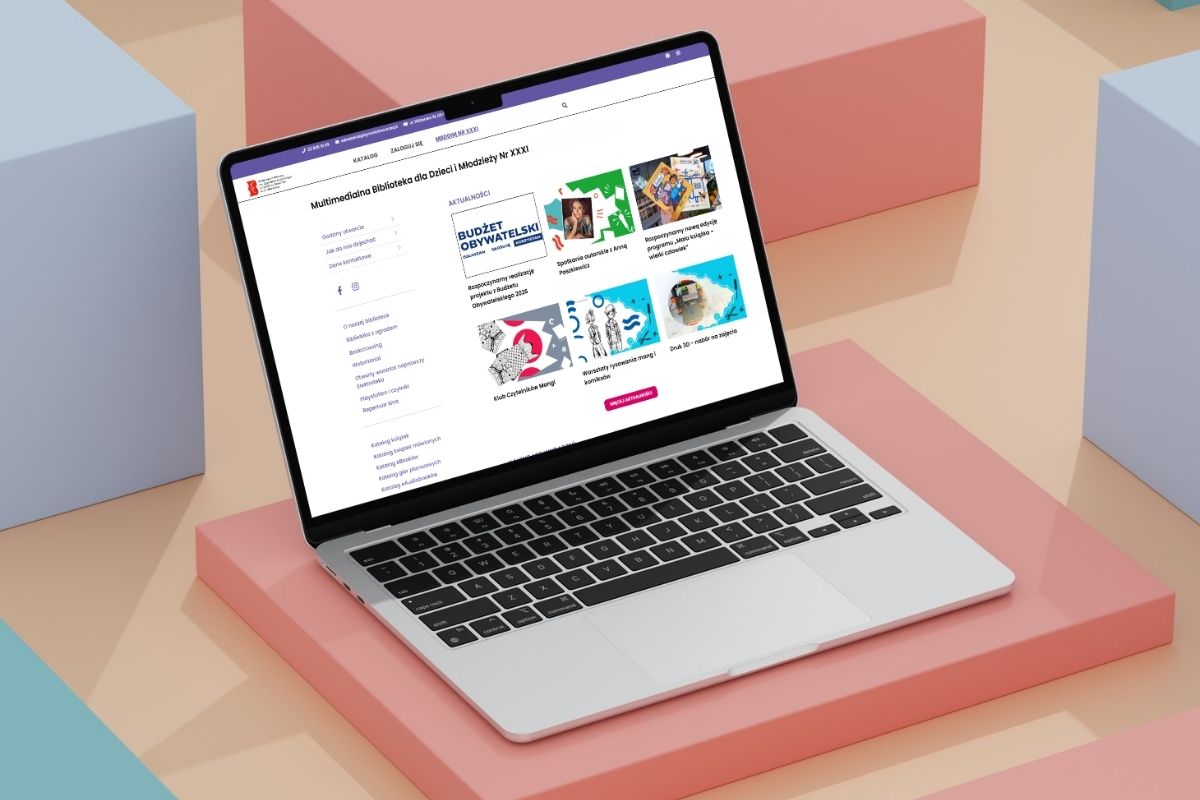 Otwarty laptop ze stroną internetową MBdDiM, w tle kolorowe sześciany