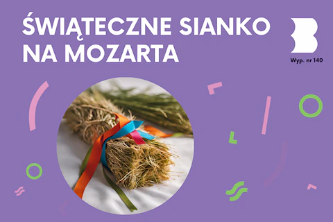 Na białym obrusie leży niewielka wiązka siana obwiązana kolorowymi wstążkami.