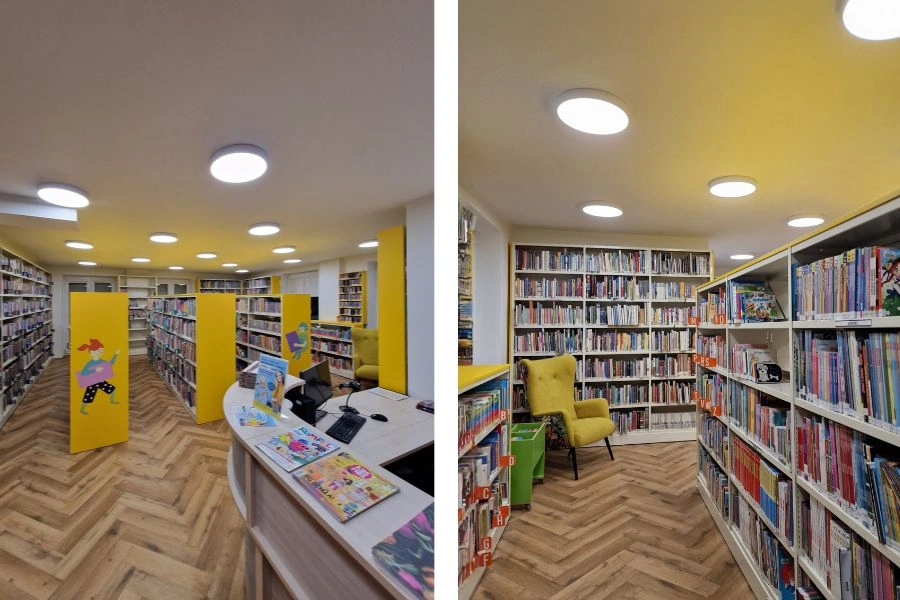 Wnętrza biblioteki, regały z ksiązkami i lada biblioteczna