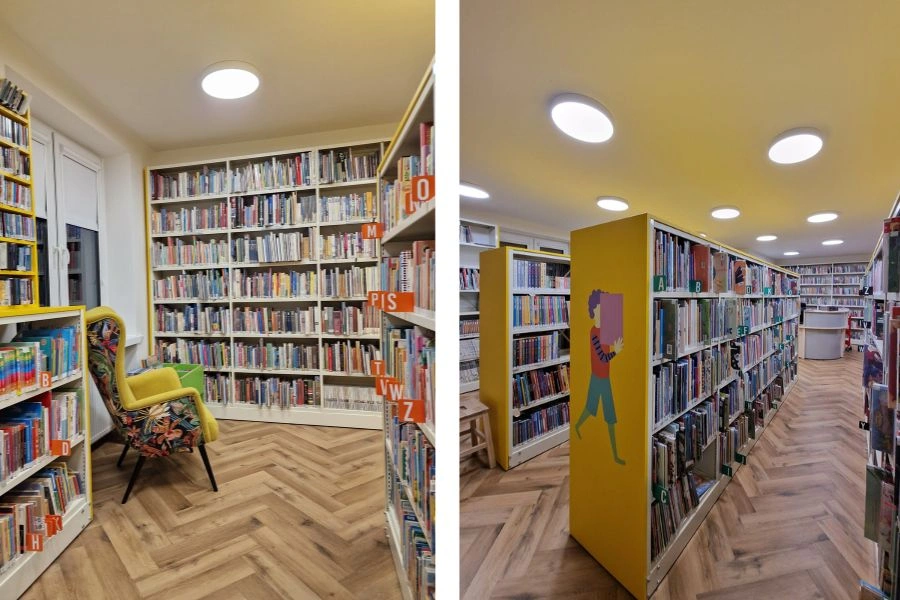 Wnętrza biblioteki, regały z książkami, fotel uszak