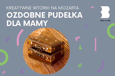 Na drewnianym stole leży niewielkie drewniane pudełko okute brązowym metalem.